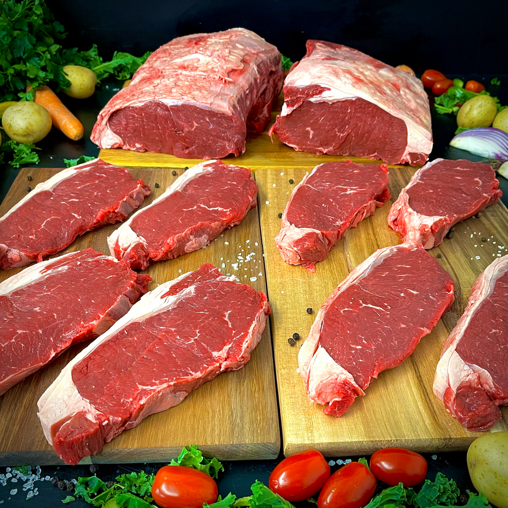Eight sirloin steaks on chopping boards