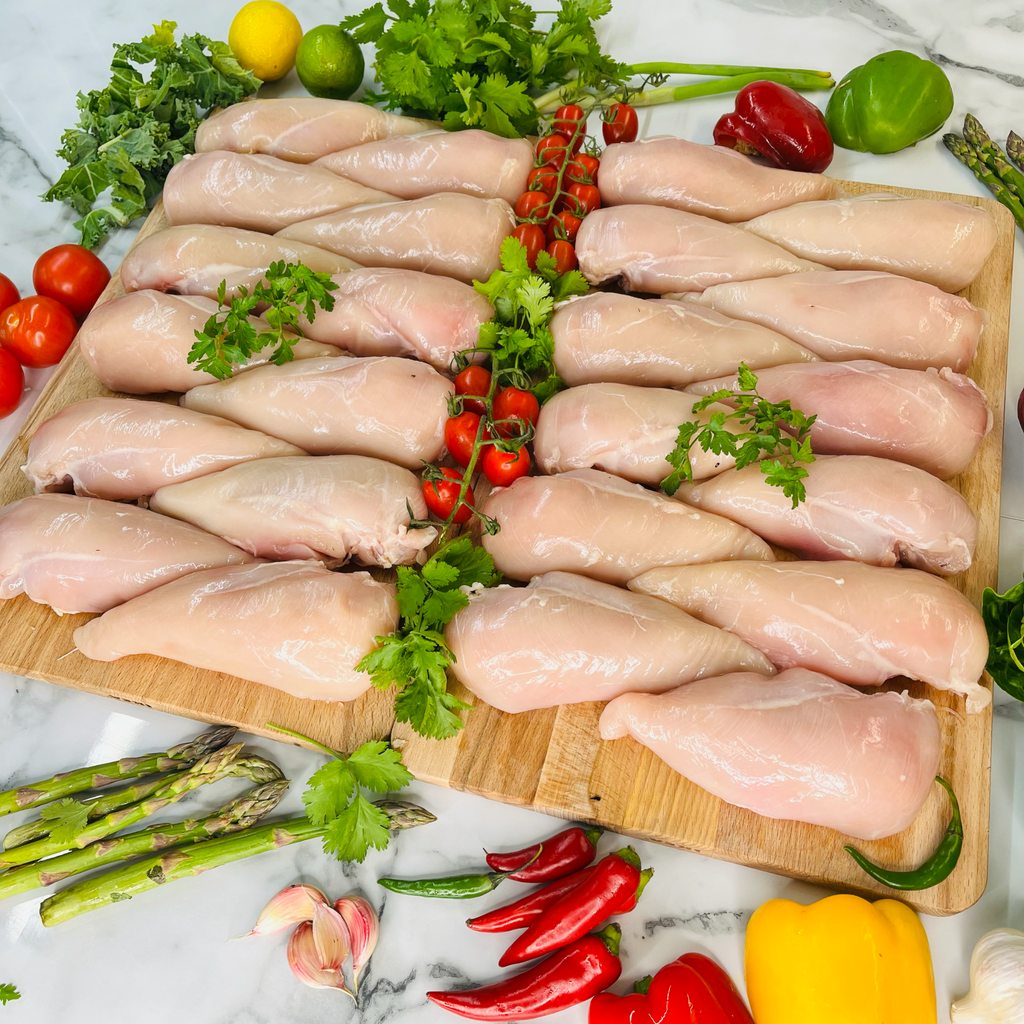 British chicken fillets and vegetables on chopping boards