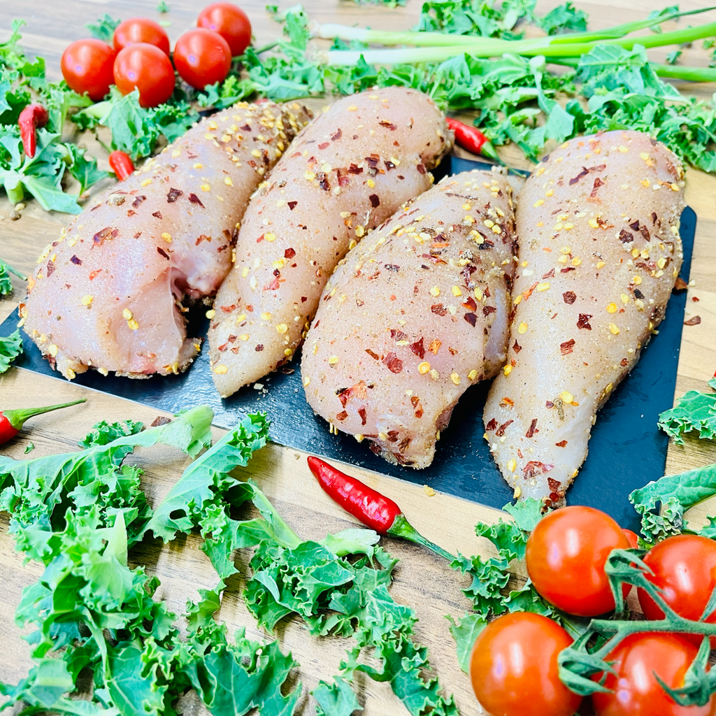 Marinated chicken breast fillets with spices and vegetables