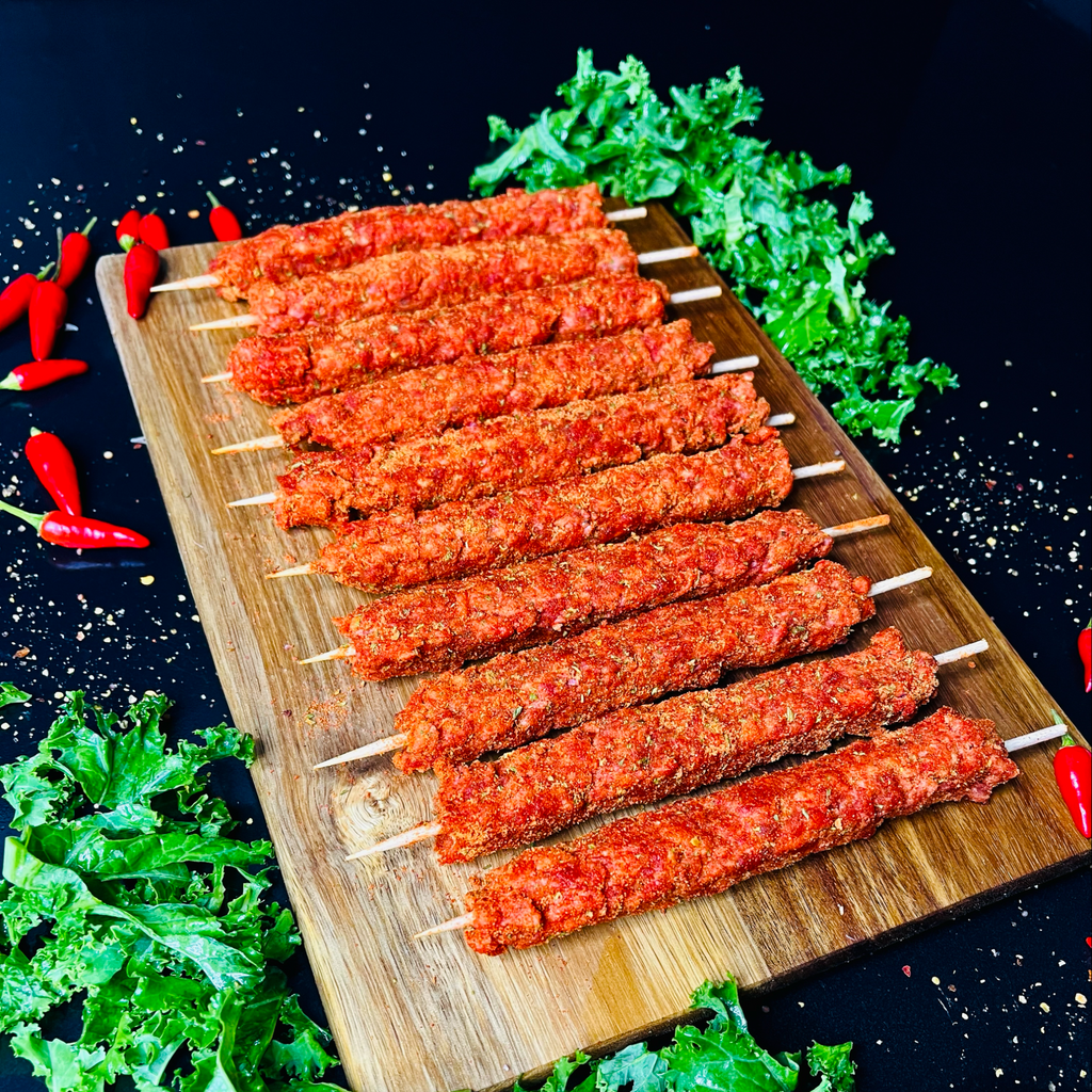 Ten beef skewers with spices on a chopping board