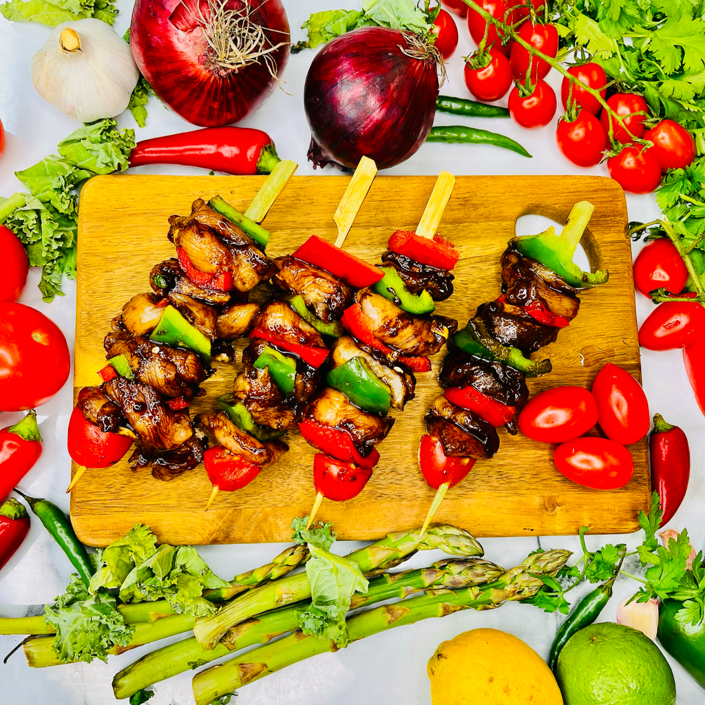 Premium Marinated Chicken Skewers with vegetables on a chopping board