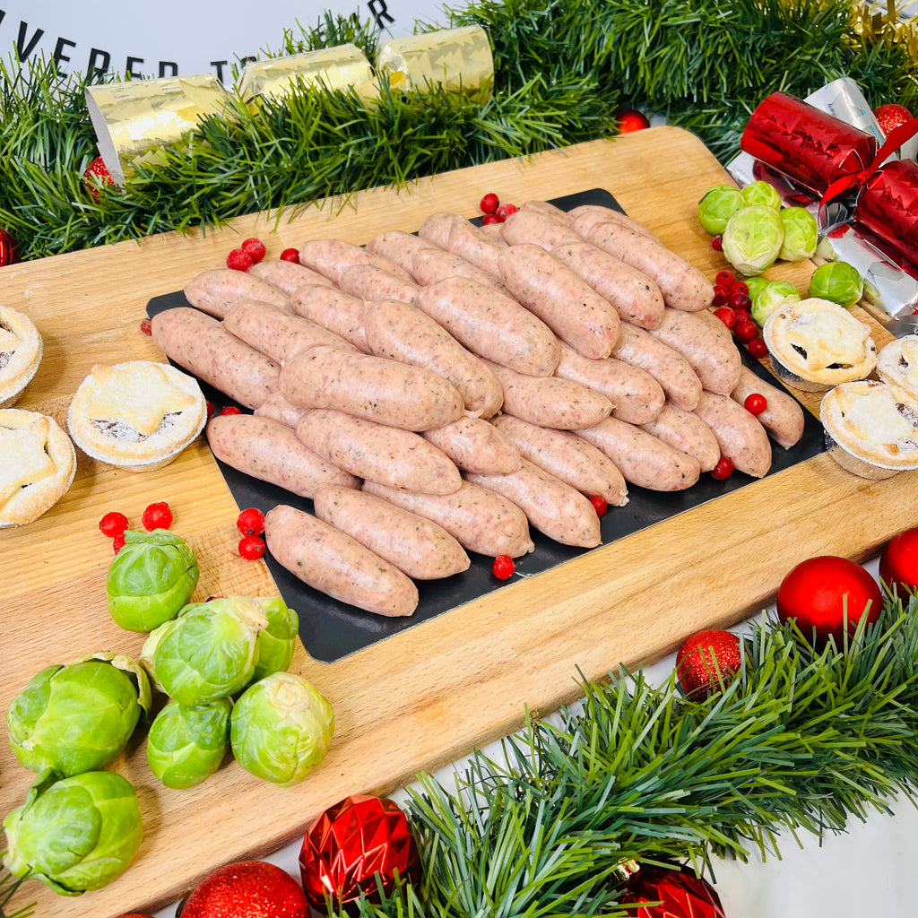 Olde English Chipolatas, mince pies and brussels sprouts on a chopping board