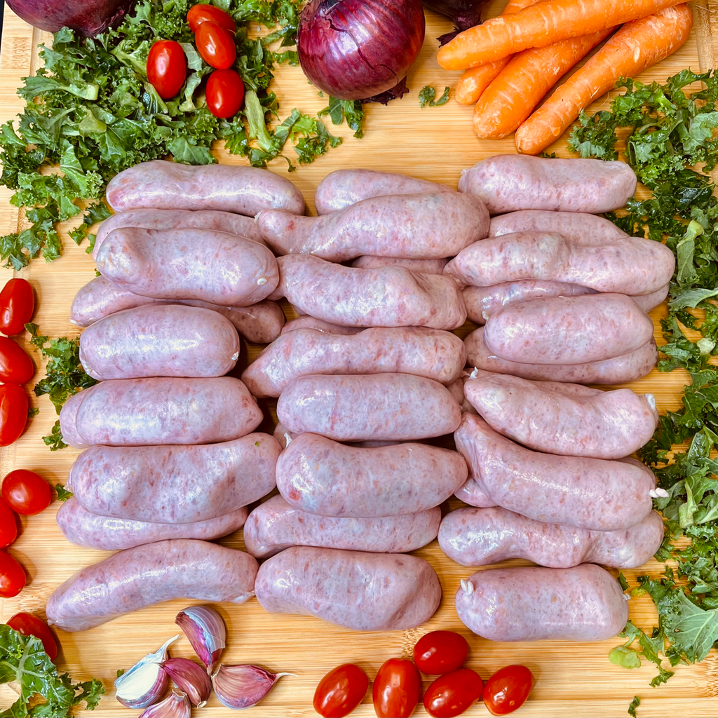 Pork and Apple sausages and vegetables on a chopping board