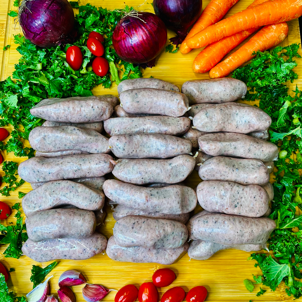 Olde English Sausages and vegetables on a chopping  board