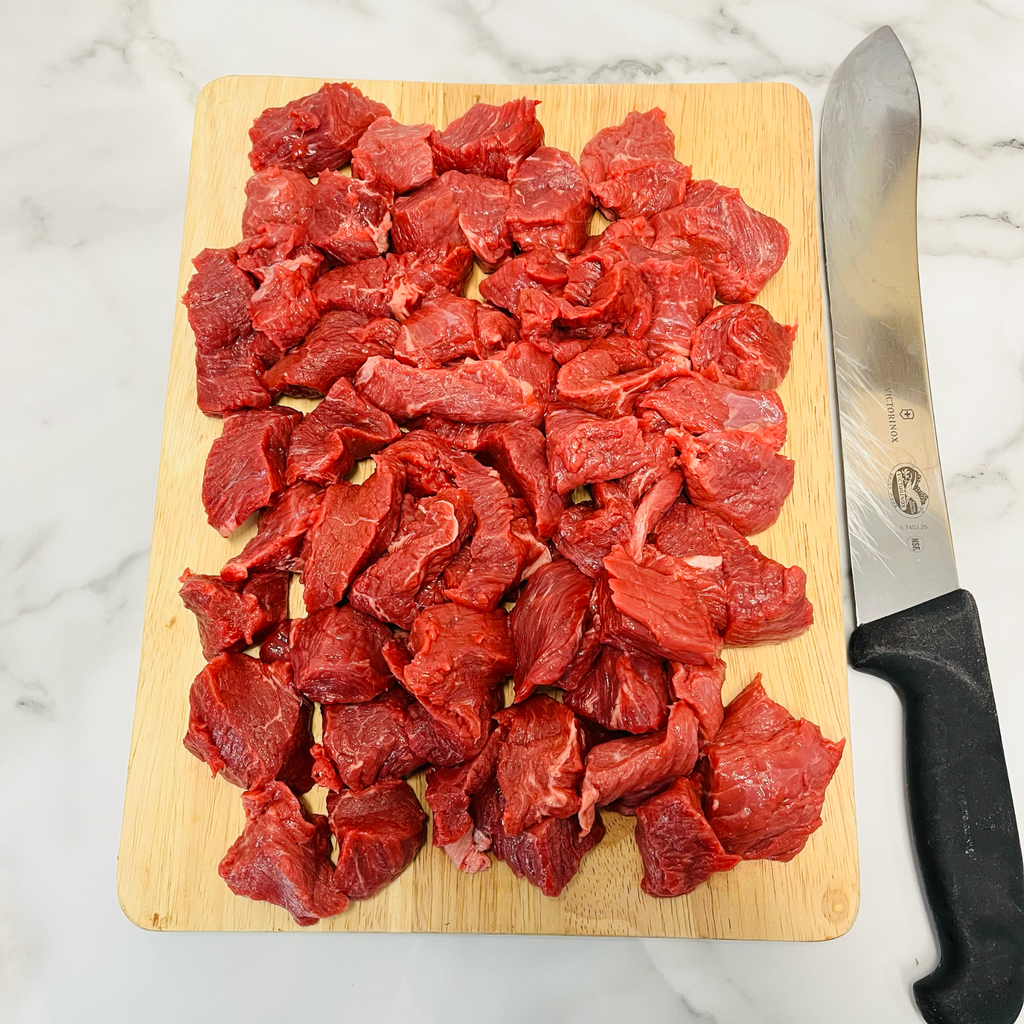 Lean diced beef on a chopping board