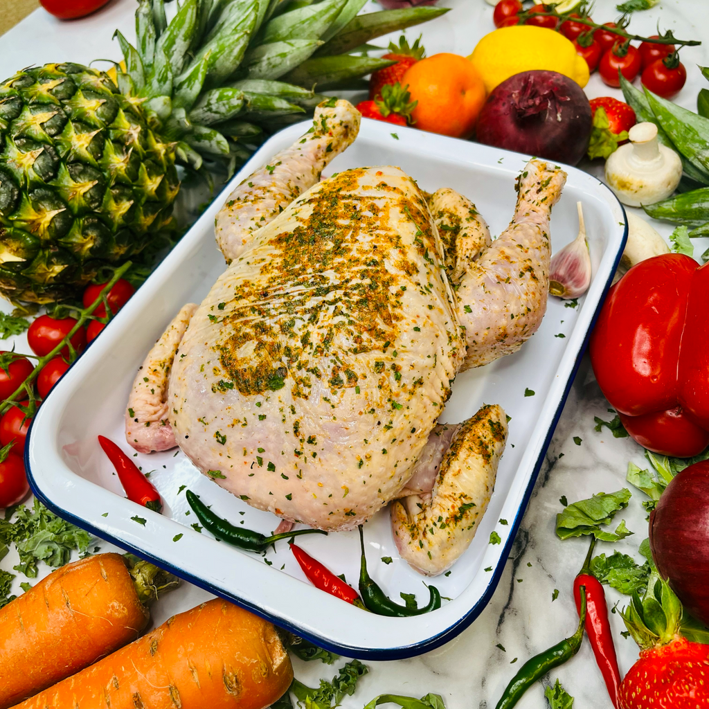 Fresh British Roasting Chicken with spices in a baking tray