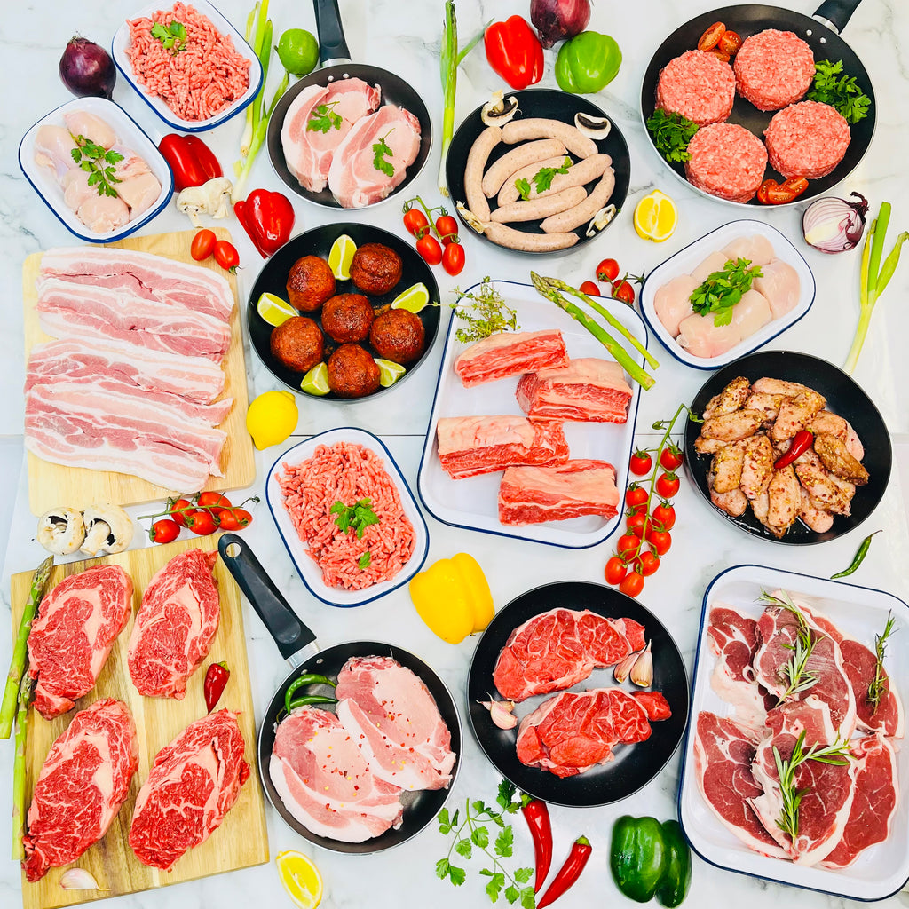 Variety of meats on plates and in pans
