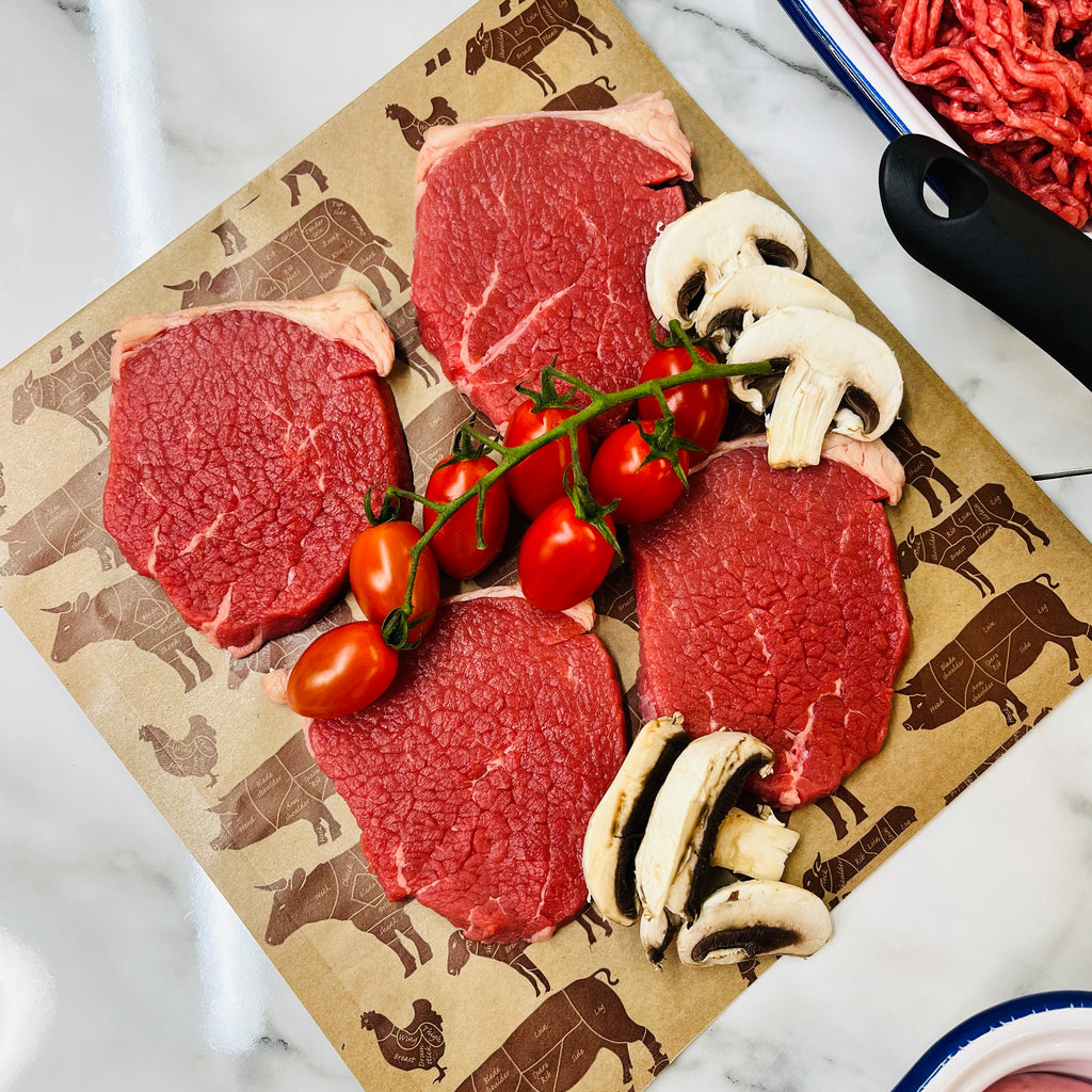 Four lean quick fry beef steaks with tomatoes and mushrooms